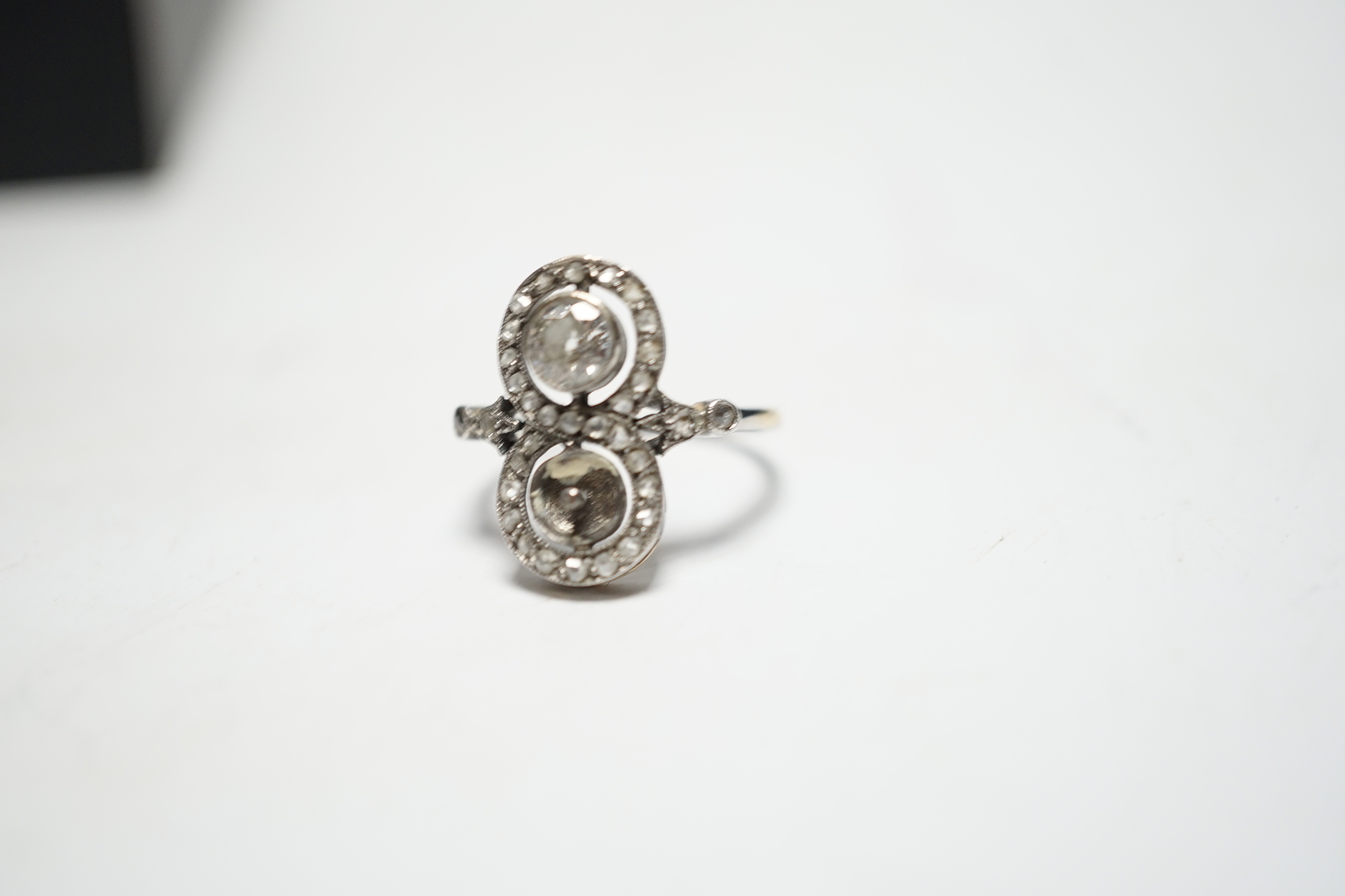 A 1920's white metal, diamond and pearl? set up finger ring, with diamond set borders and diamond set shoulders, (pearl missing), size J, gross weight 2.7 grams.
